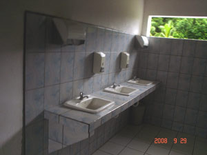 The facilities include a bank of modern tiled hand basins.